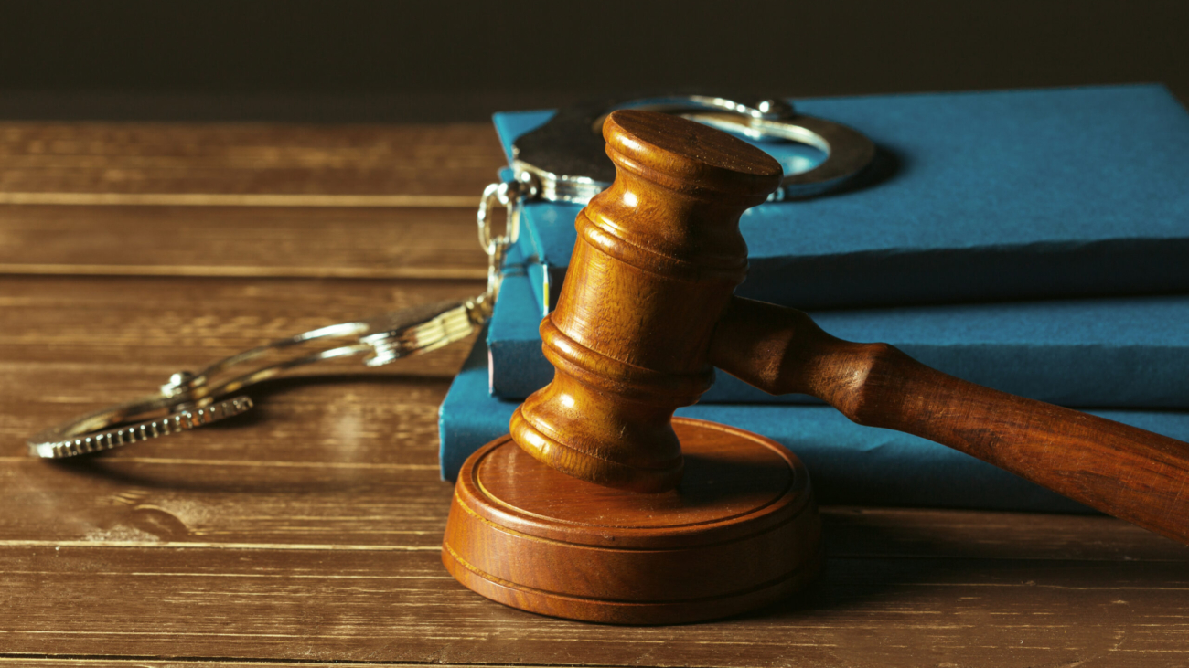 Gavel With Books On Old Wooden Desk